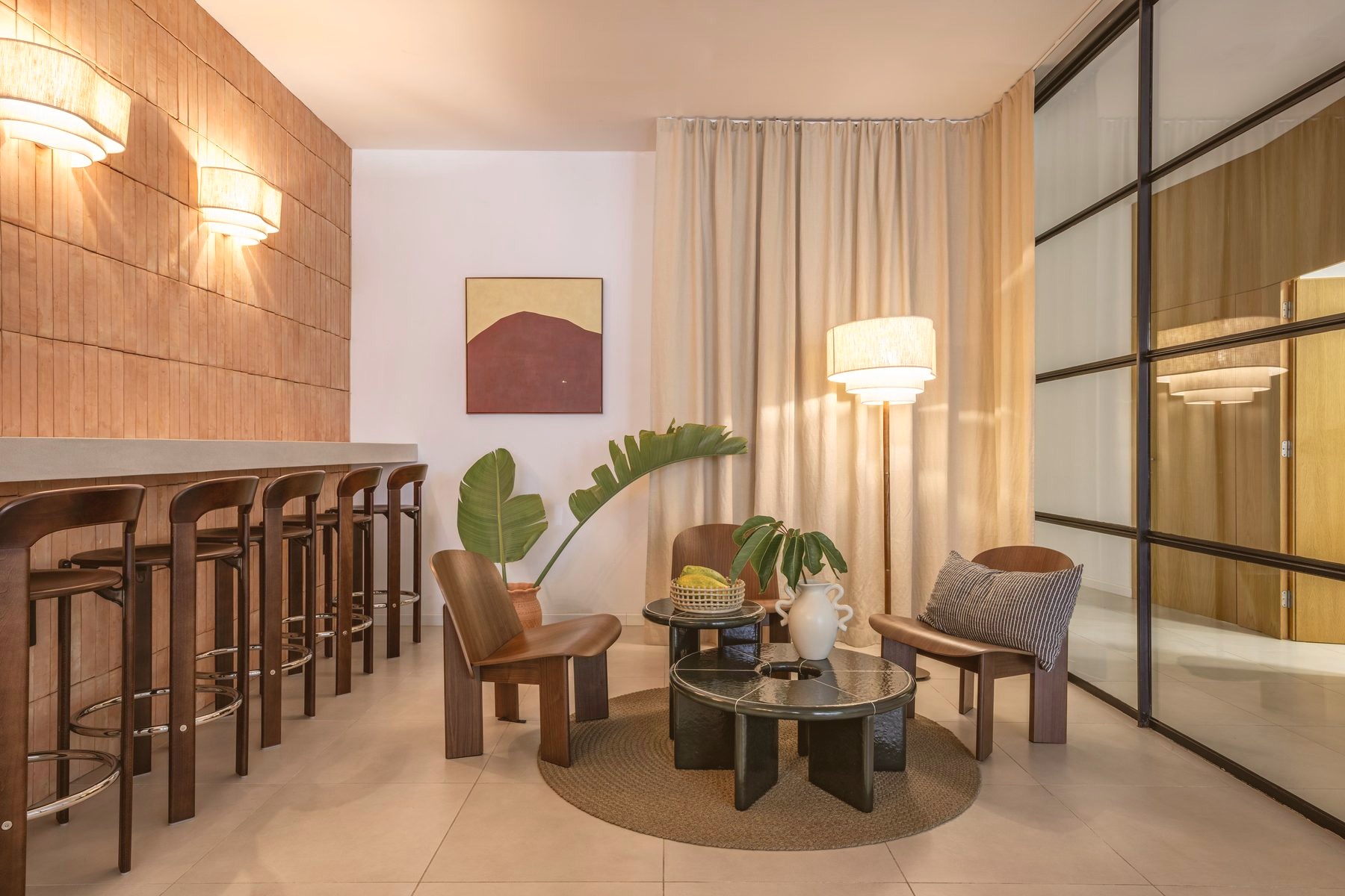 Reception area with wall sconces, potted plants, and bar seating