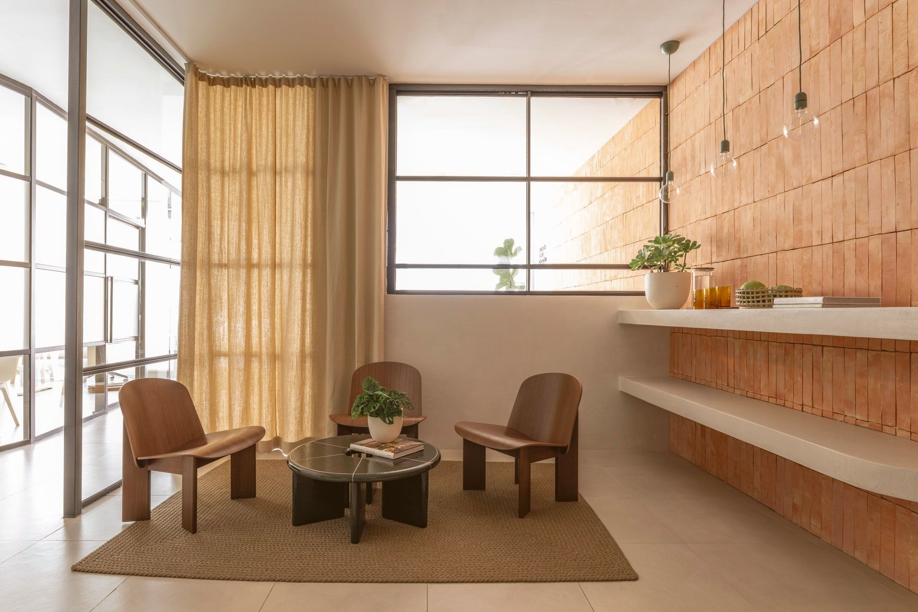 Reception desk and lounge seating arranged along the tiled wall