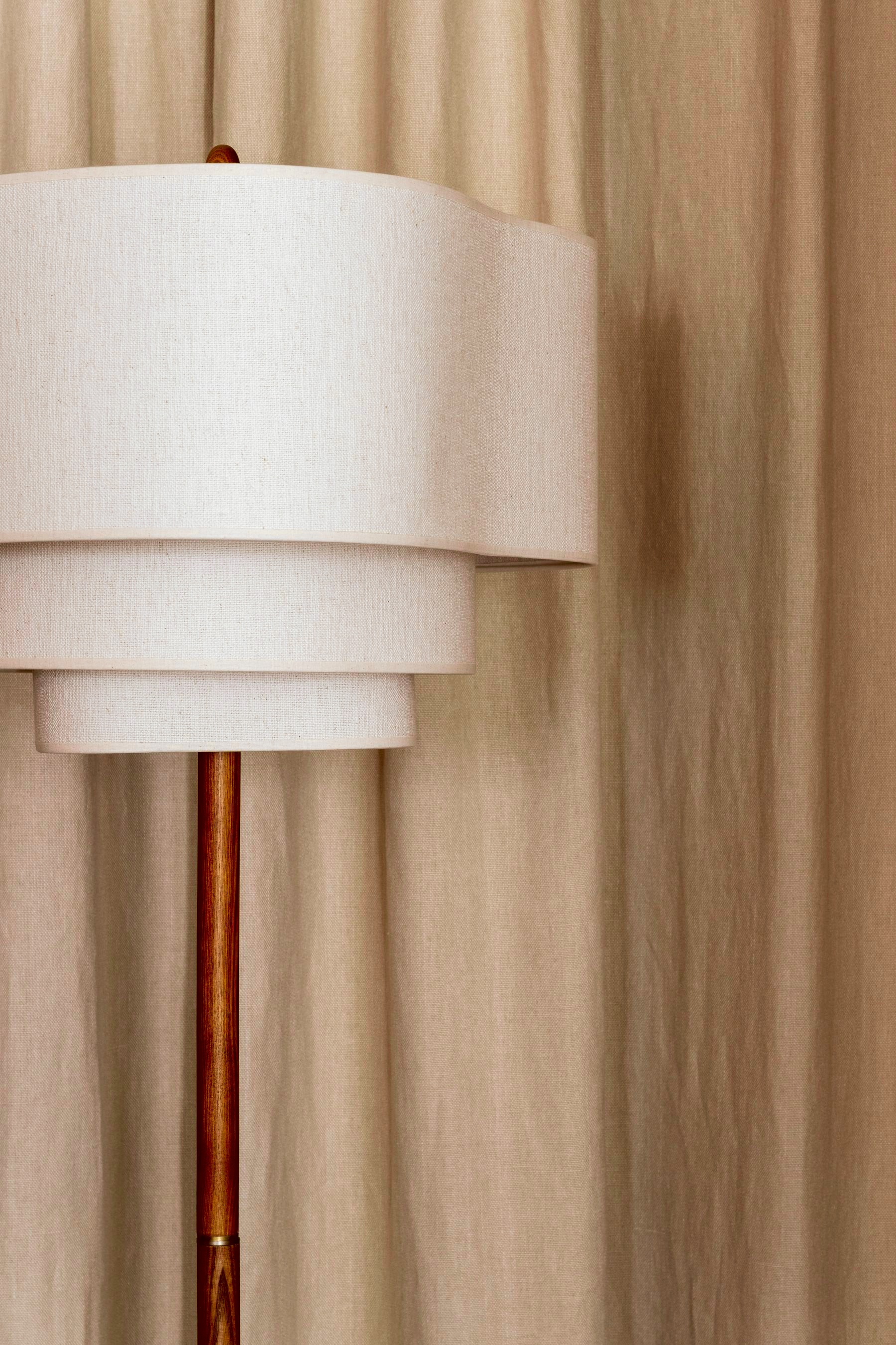 Wood-slat wall detail with wall sconces above the bar stools