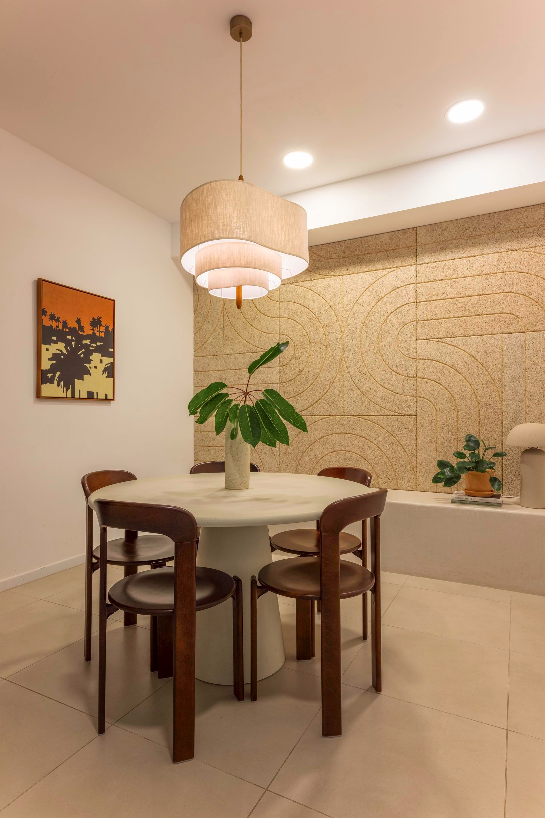 Meeting room with a round table, pendant light, and framed artwork