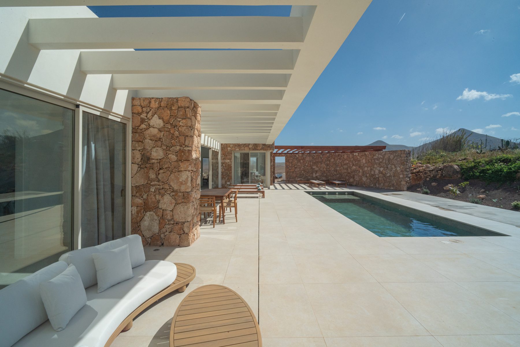 Elevated terrace corner framed by pergola beams