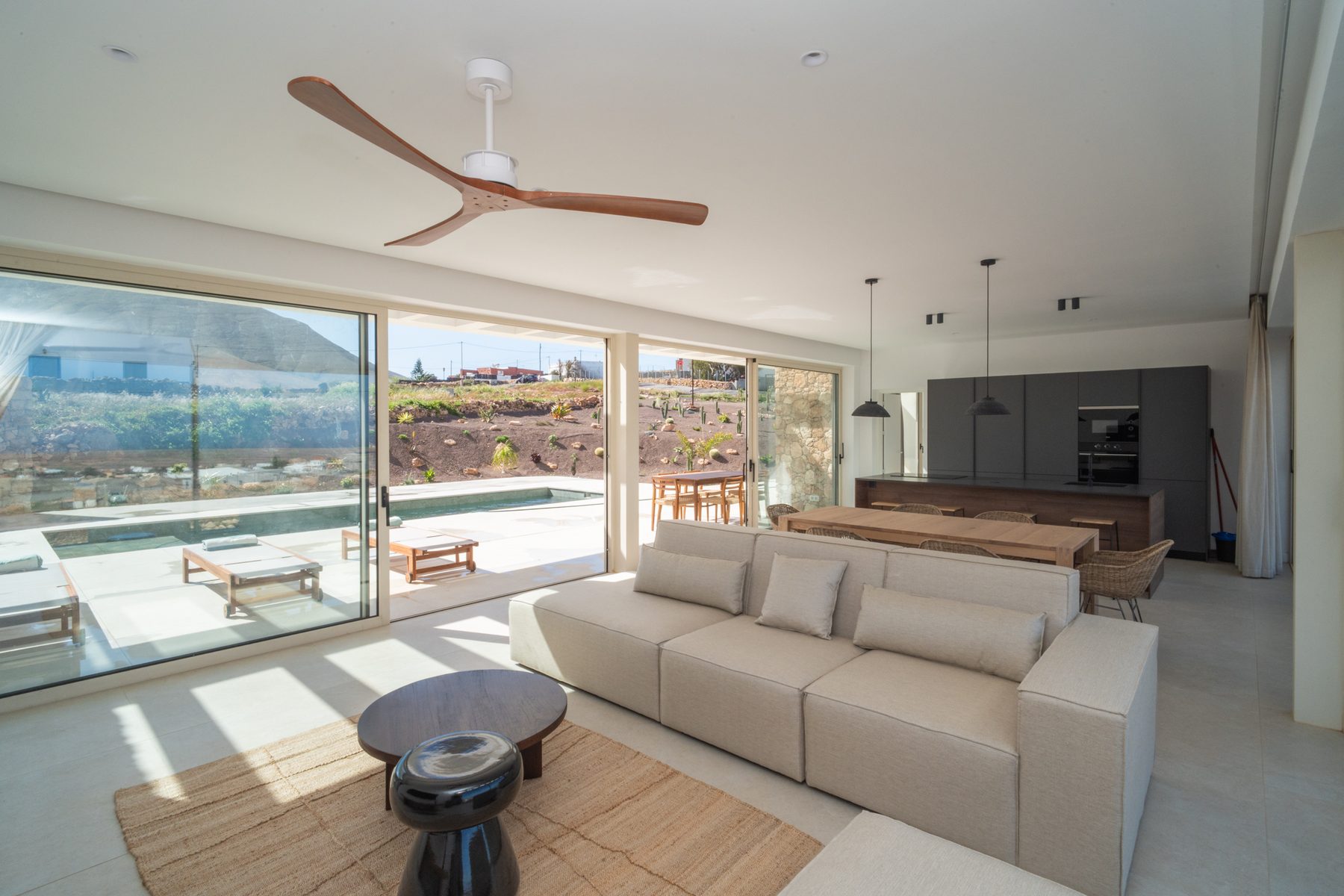 Dining table beside sliding glass doors with a mountain view