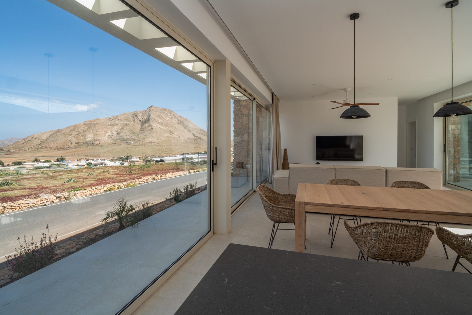 Villa exterior terrace with pool and pergola shading, mountain backdrop